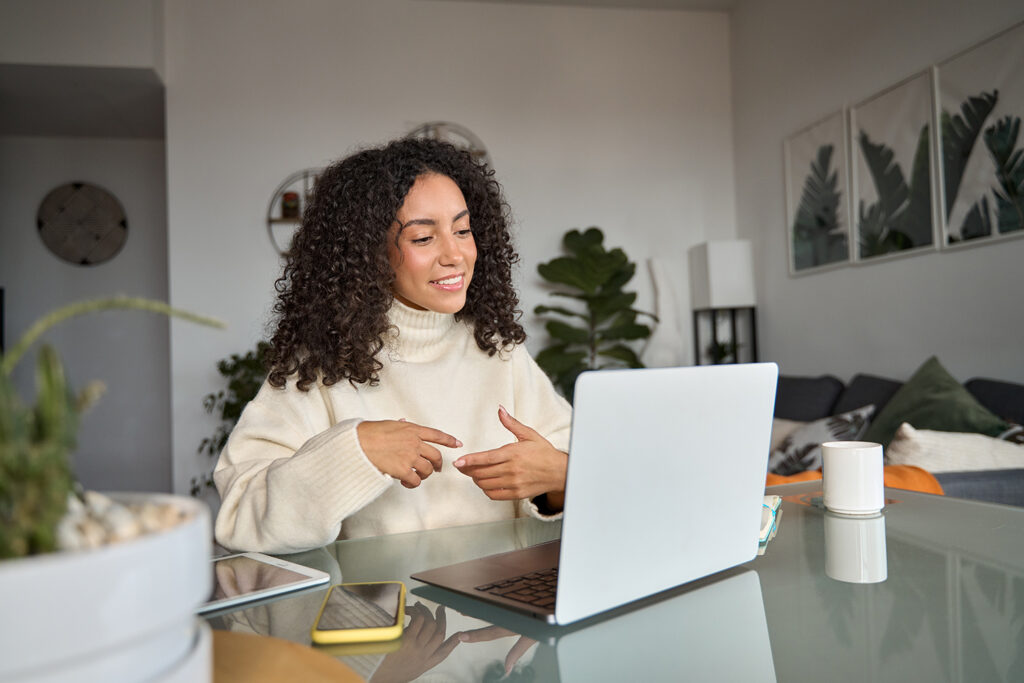 Woman talking to client on computer