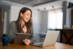 woman working on computer and ipad