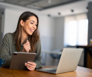 woman working on computer and ipad
